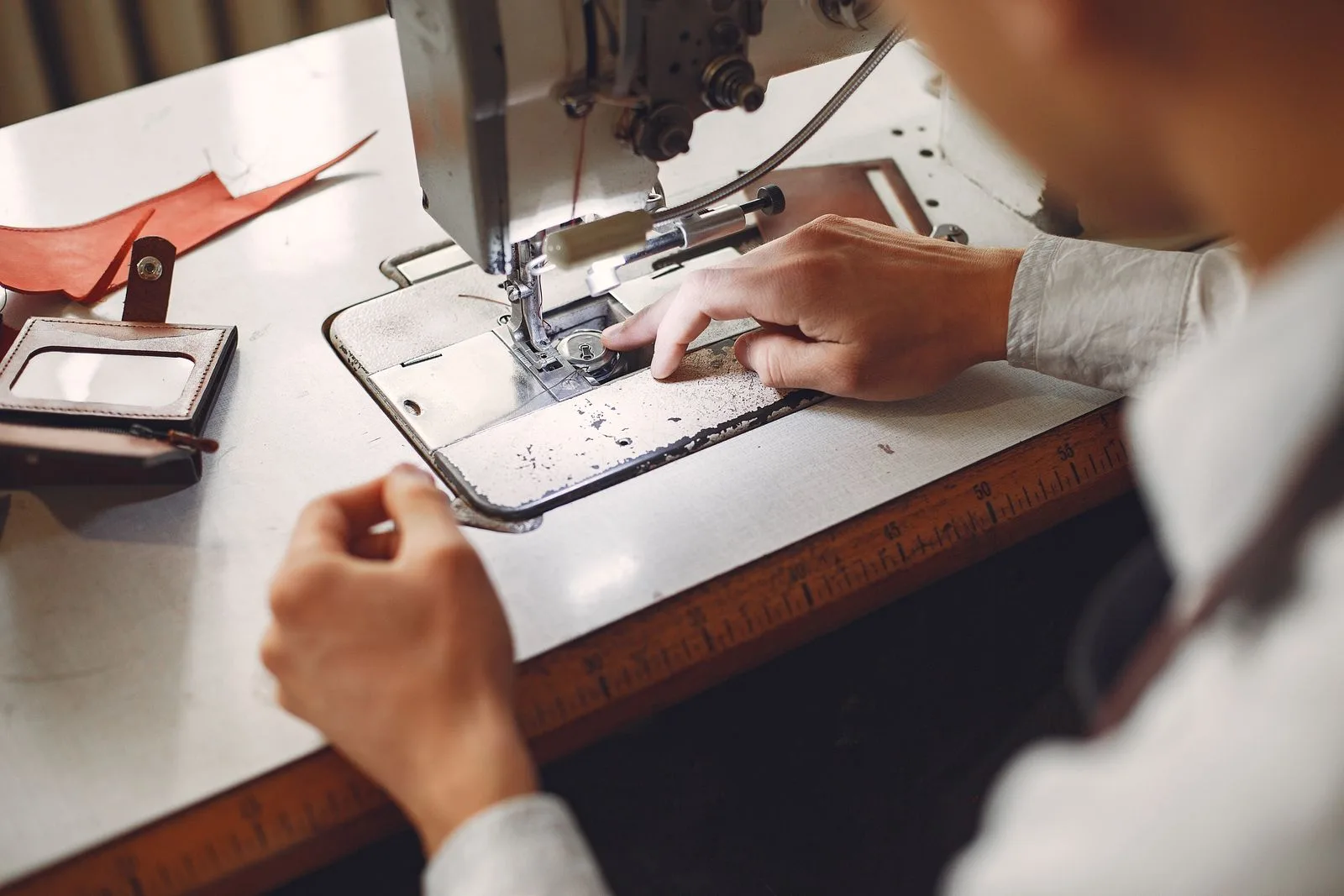 Leather cutter working a hide on a workshop table