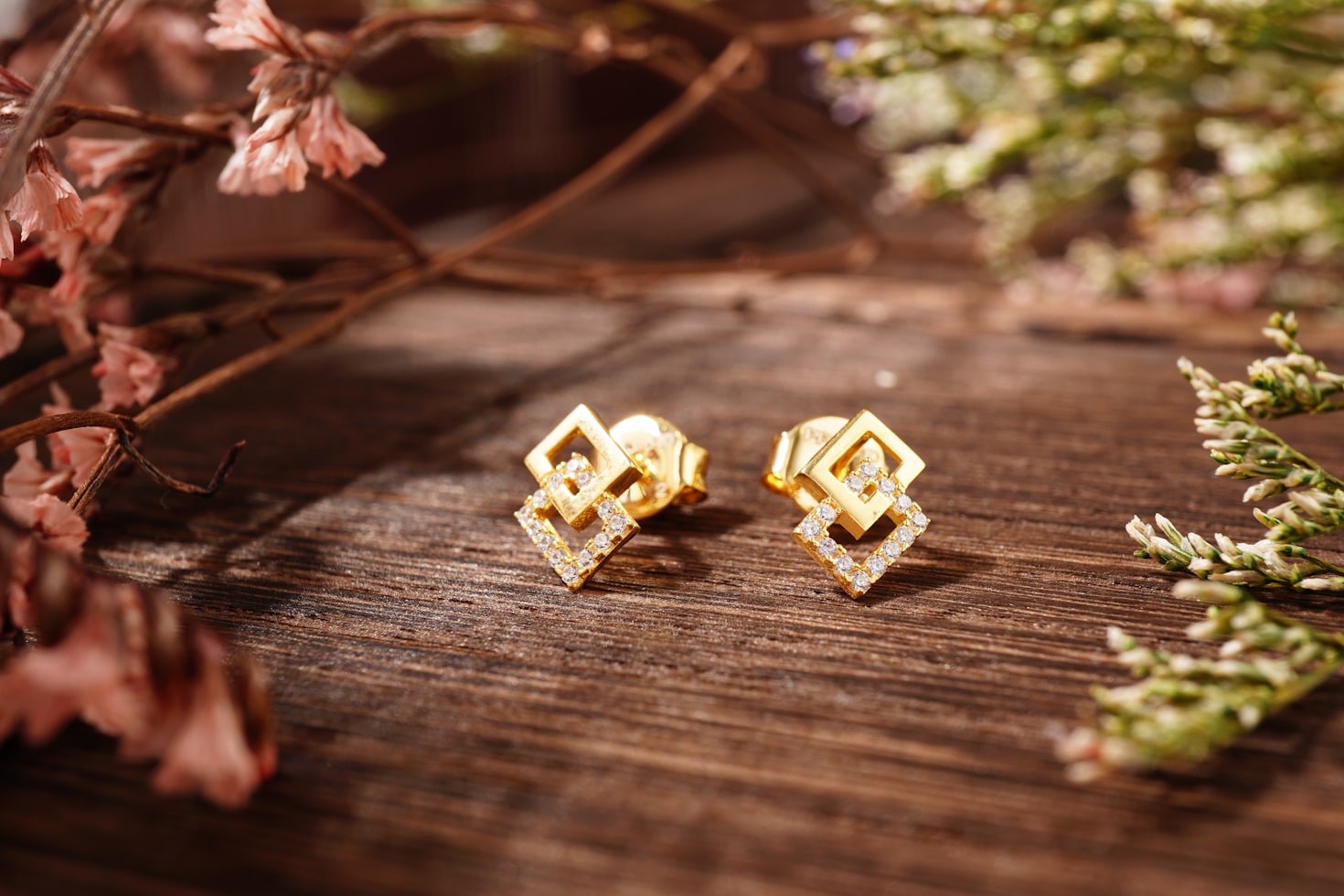 Mismatched earrings on a woman's ear, asymmetric designer pair from a French jewelry maker