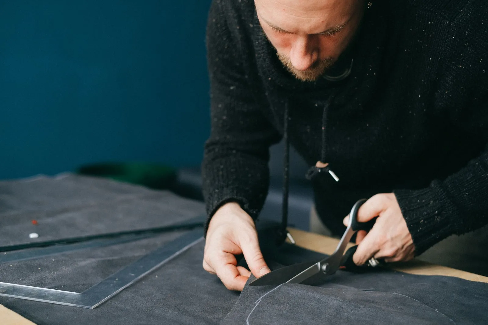 Leather hide on a workshop table with a measuring tape