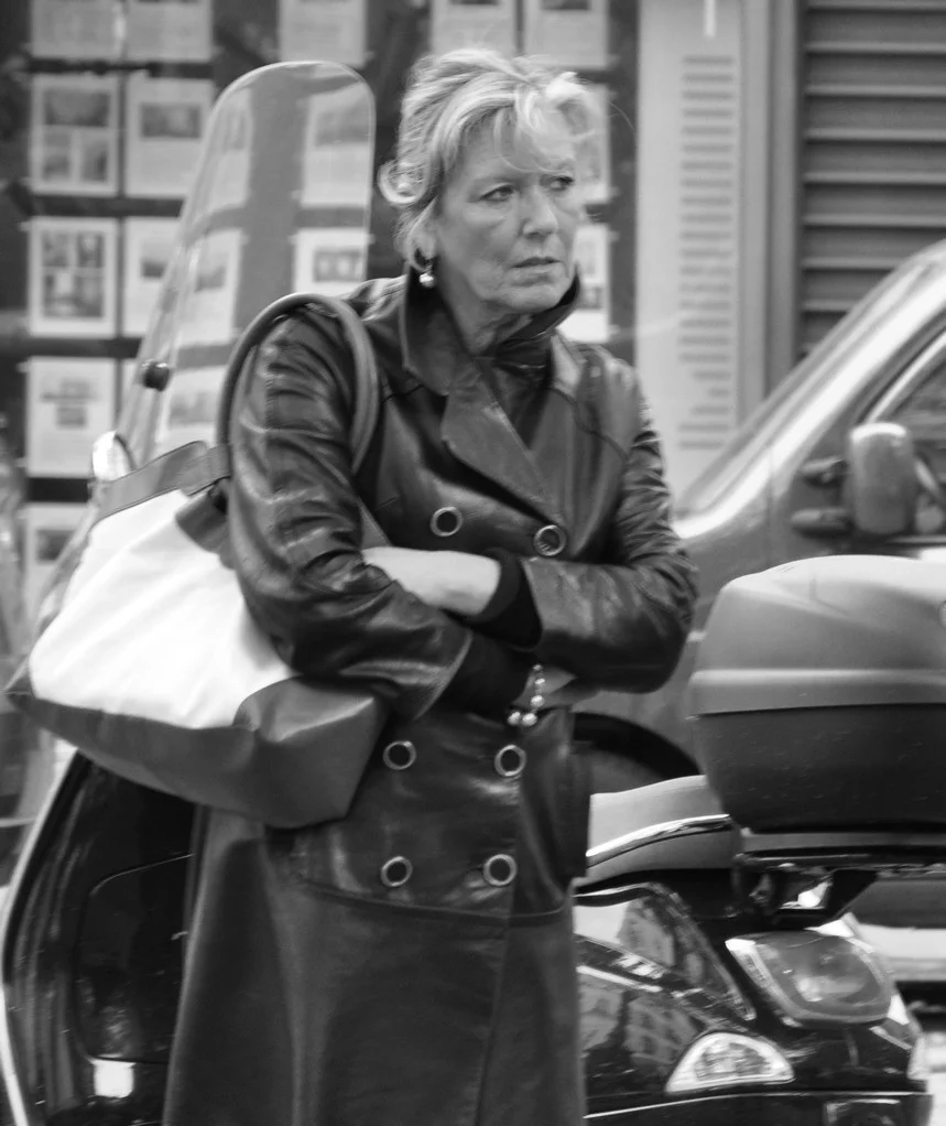 Woman wearing a black leather biker jacket on a Paris street