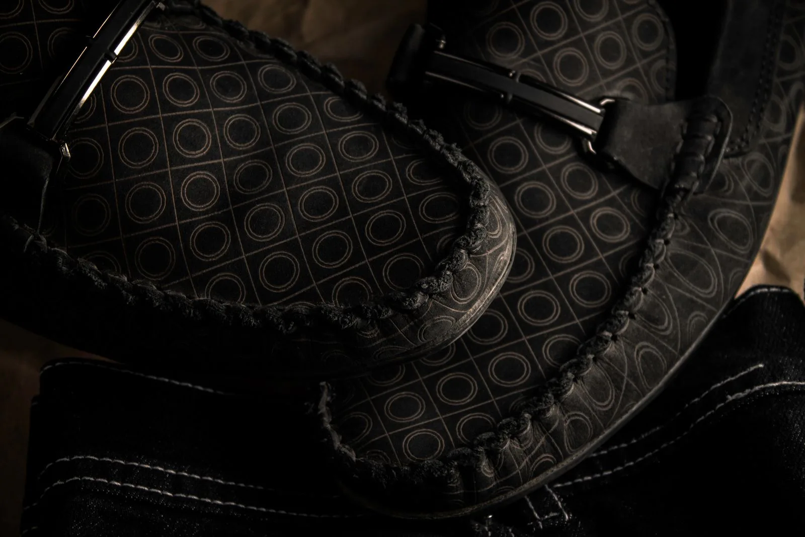 Patterned leather loafers photographed on the ground
